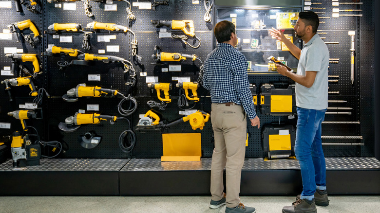 Two men looking at a DeWalt tool display