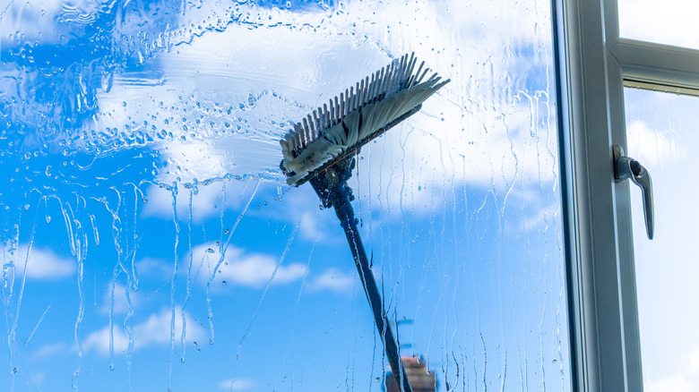 Cleaning brush washing an exterior window