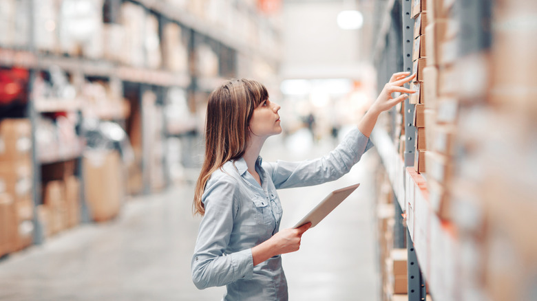 Woman shopping in warehouse aisle