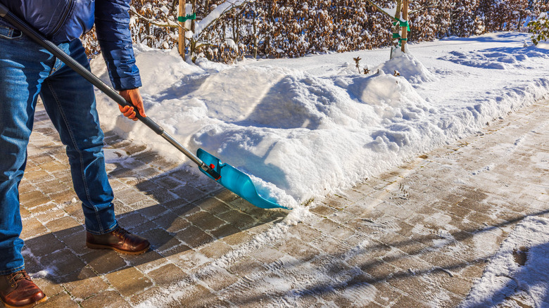 Someone shoveling snow from a walkway