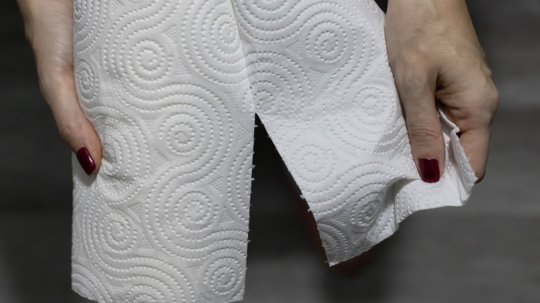 hands tearing paper towel
