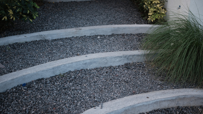 Stair steps on an incline made with gravel and cement.