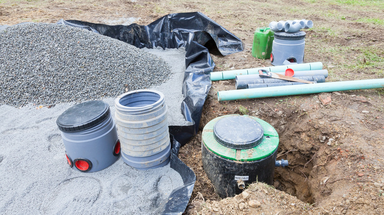 Septic system parts and gravel ready for installation