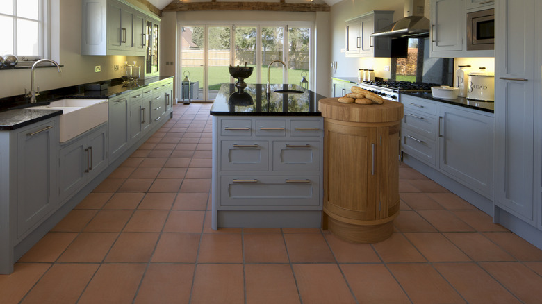 Kitchen with brown tile floors