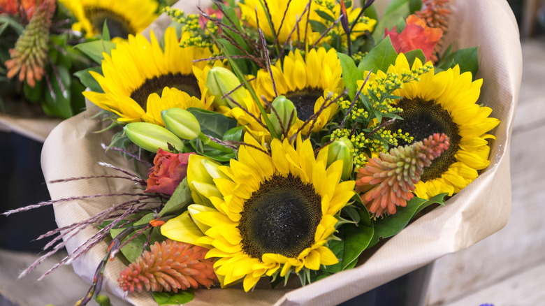 Bouquet of sunflowers and other flowers wrapped in paper