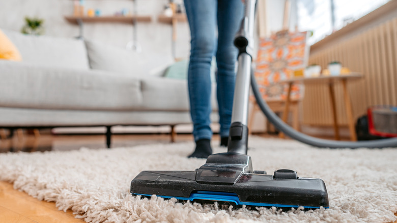 woman vacuuming shag carpet