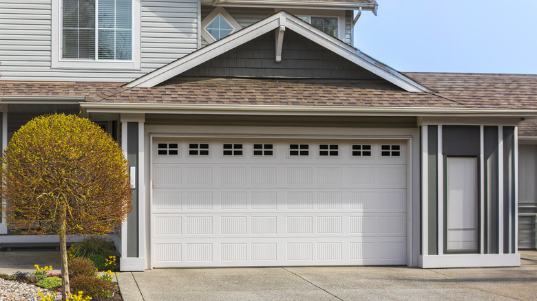 traditional composite garage door on attached home