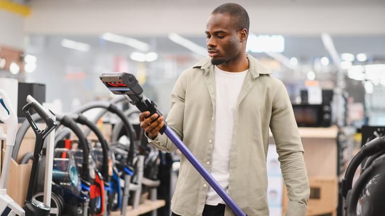 Man shopping for vacuums