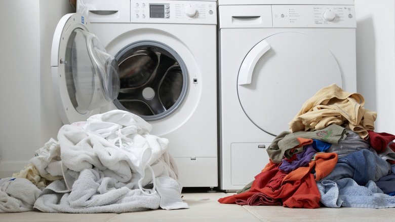 Whites and colors in separate piles in a laundry room