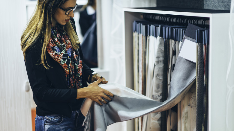 Woman searching through curtains