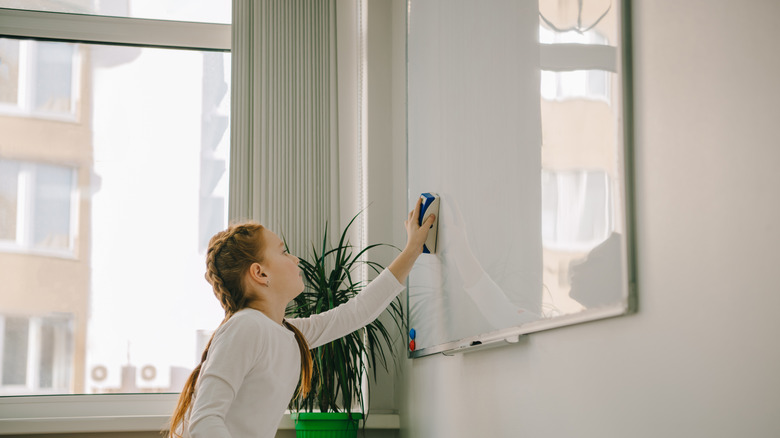 woman cleaning whiteboard