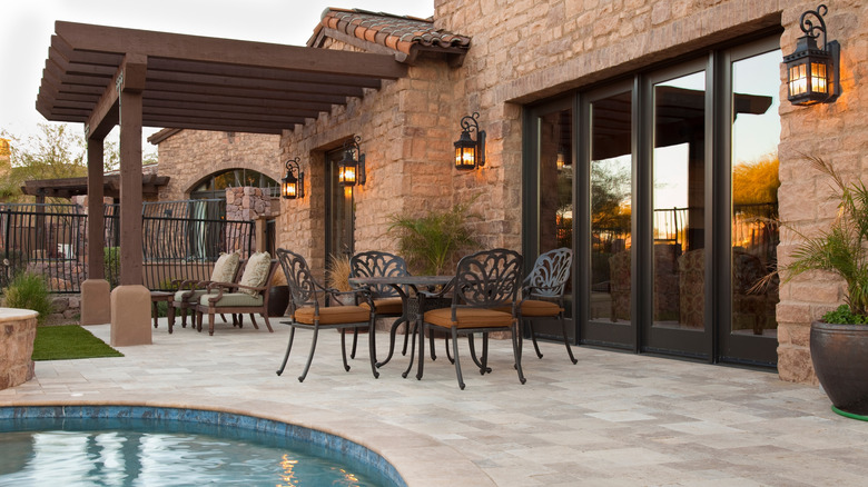wrought iron patio set by a pool