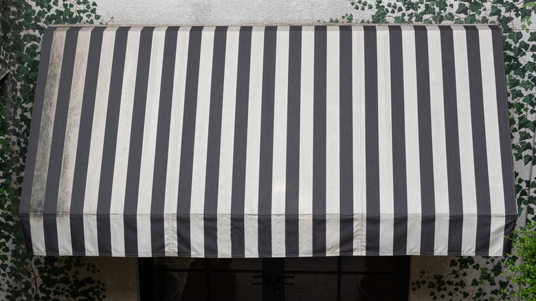 dirty black and white striped awning