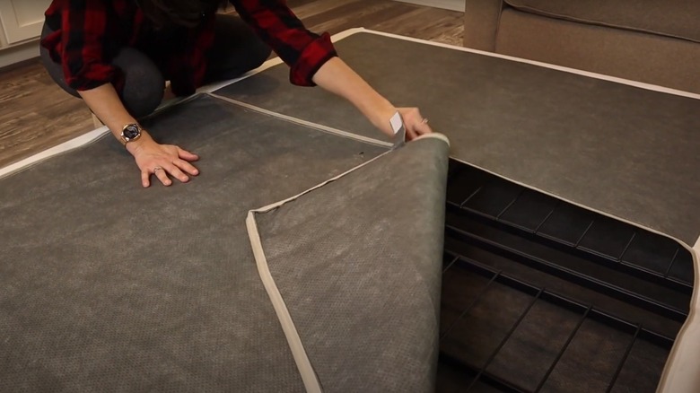 person unzipping box spring cover