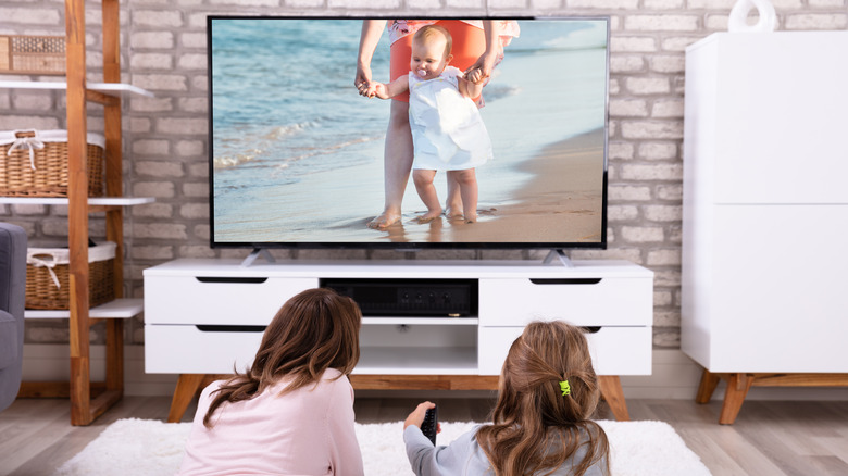 mother and daughter watching tv