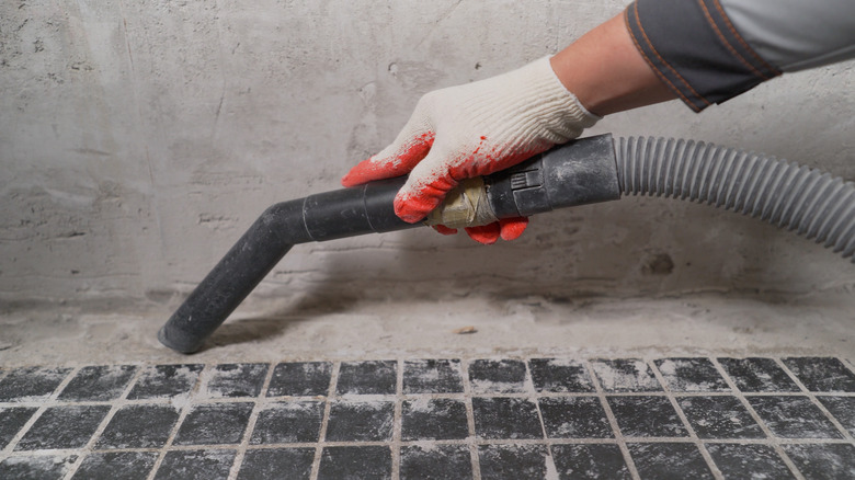 vacuuming tiled floor with hose