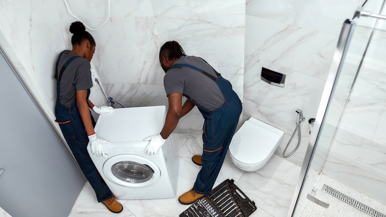 People moving washing machine