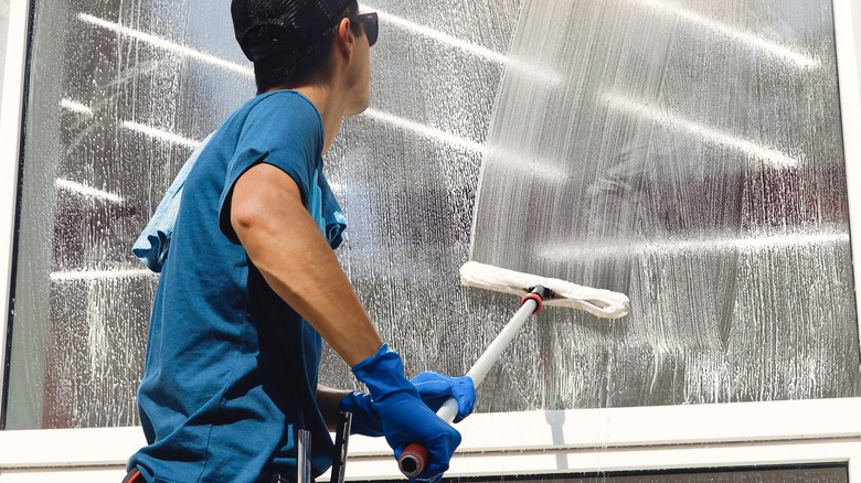 man cleaning window