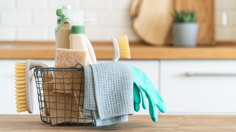 Basket of cleaning supplies on a counter