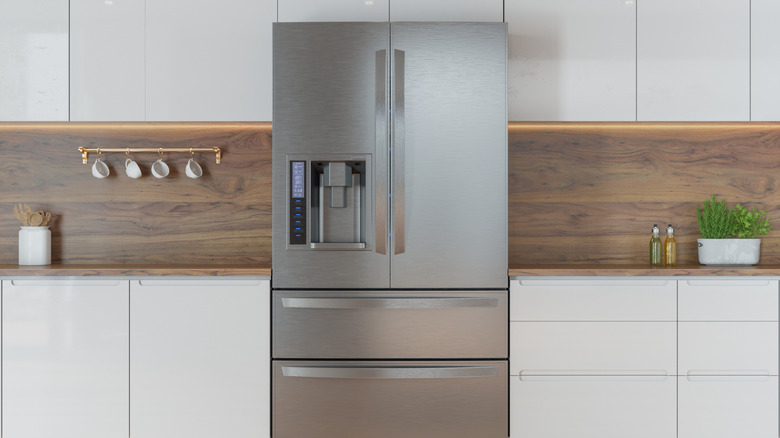 Stainless steel refrigerator in white kitchen