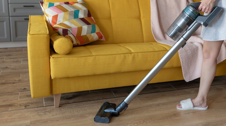 Vacuuming around a couch