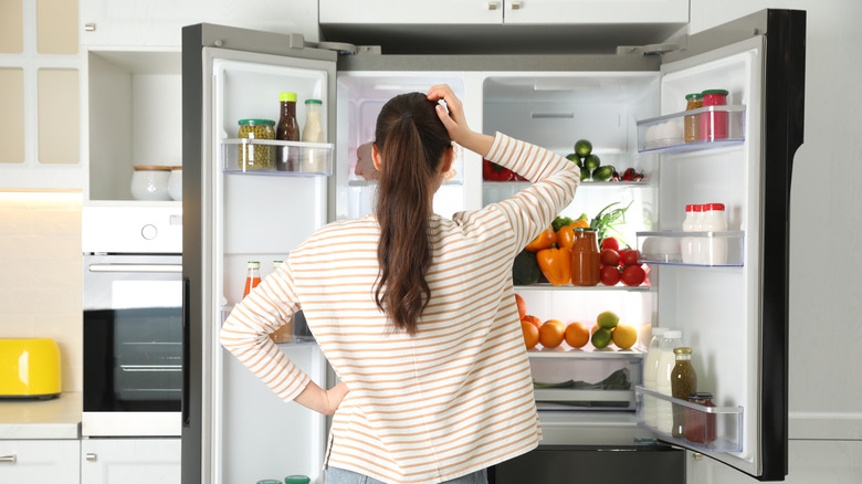 woman looking in fridge 