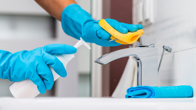 Person cleaning sink