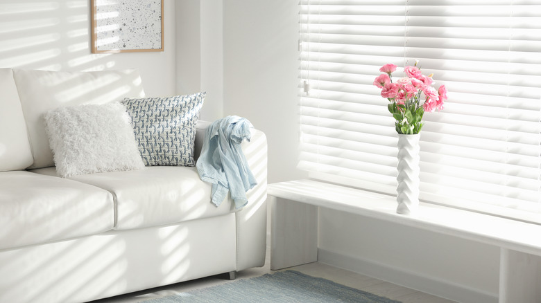 Couch with blinds and flowers
