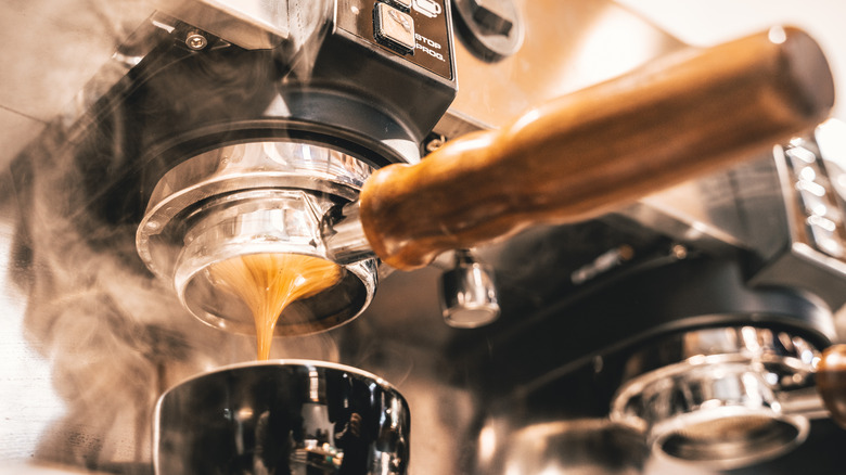black coffee maker brewing an espresso