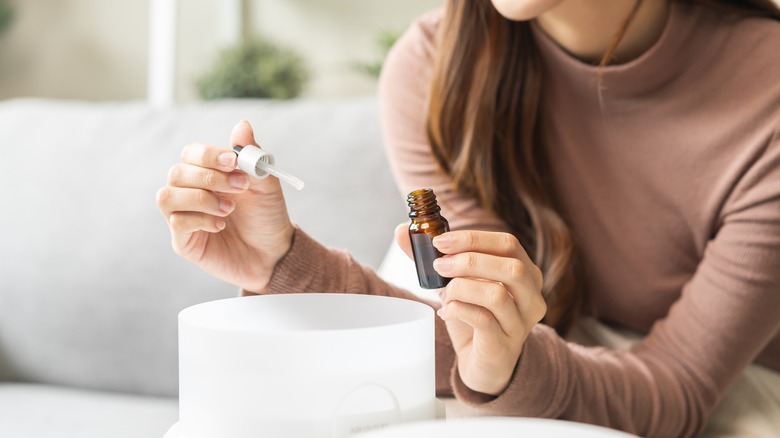 Woman using oil diffuser 