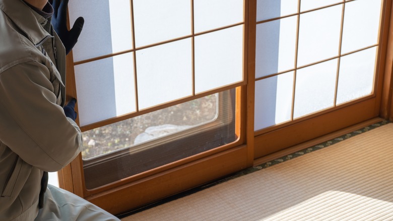 Man fixing  wooden sliding door