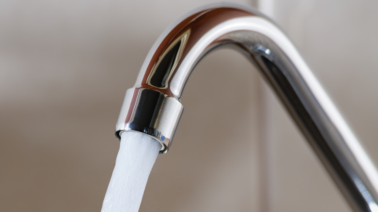 Water flowing from curved faucet