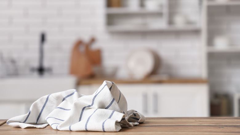 A clean striped towel sits on a kitchen counter