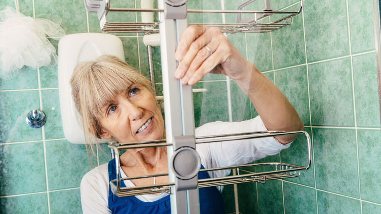 woman removing shower caddy