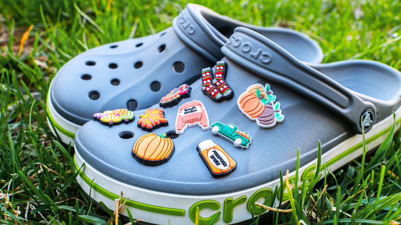 Croc shoes in grass with charms