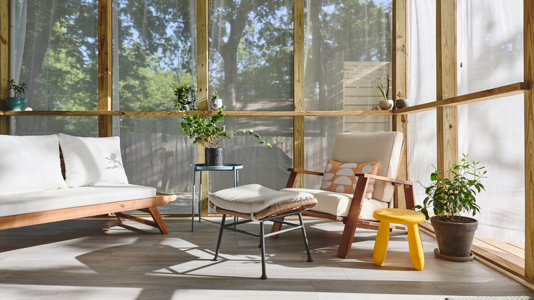 Screened porch with mid-century furniture