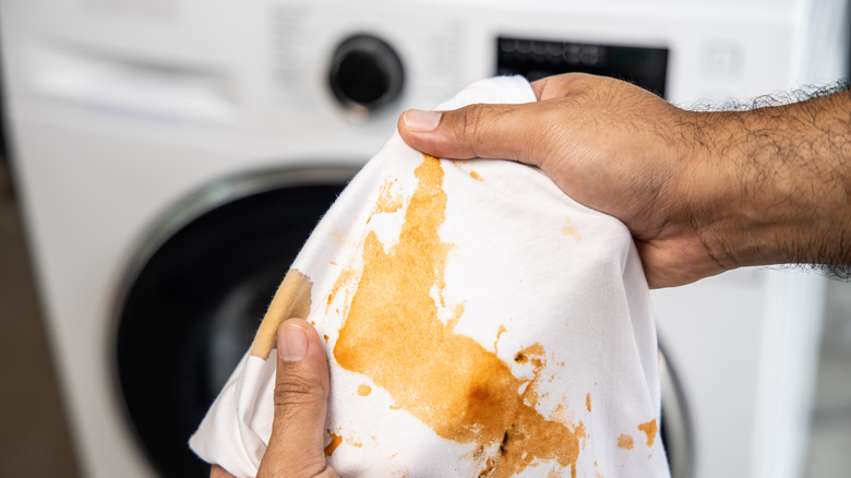 holding stained shirt