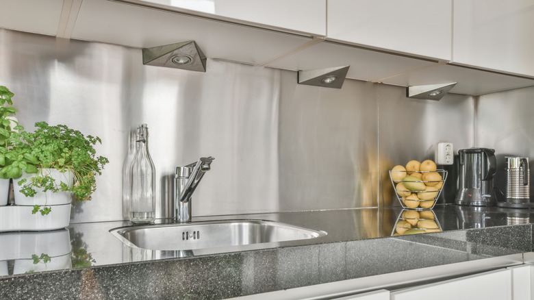 Modern kitchen with stainless steel backsplash wall