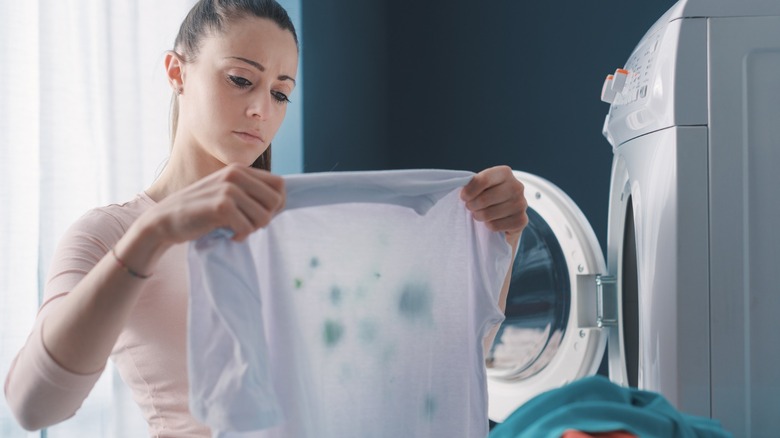 Woman holding stained laundry