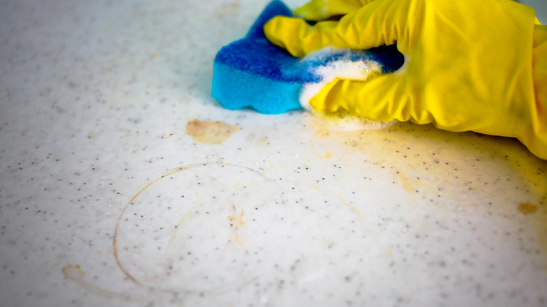 Person cleaning dirty countertop