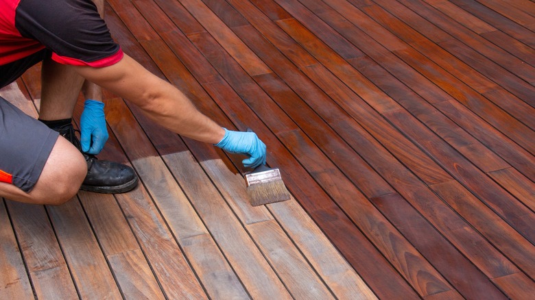 Man applying paint stain