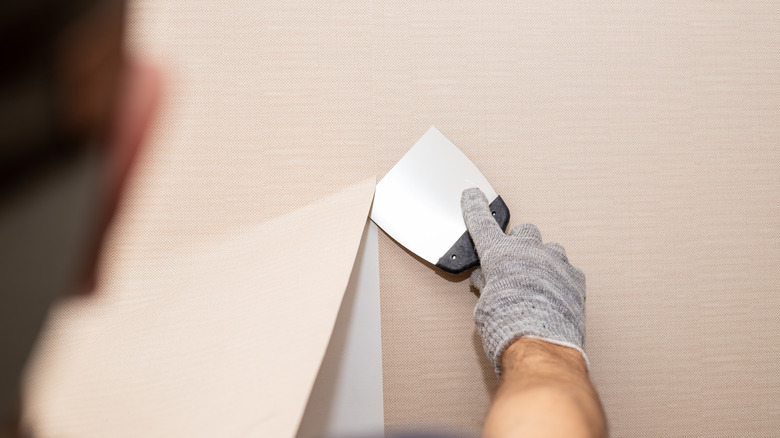 man removing wallpaper