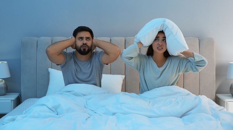 Couple suffering from noisy neighbors