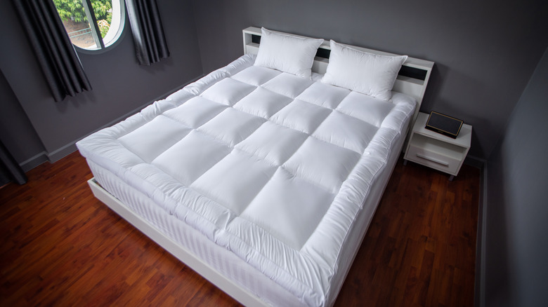 White mattress topper on bed
