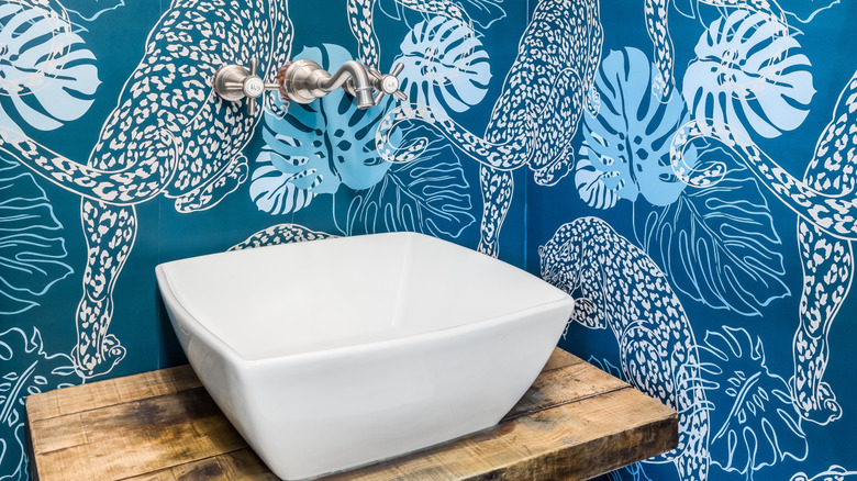 bold wallpaper in a muted maximalist bathroom