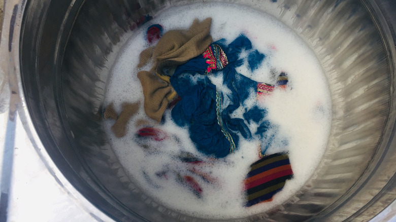 Dark clothes and sudsy water in a washing machine