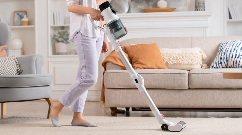 Woman vacuuming living room