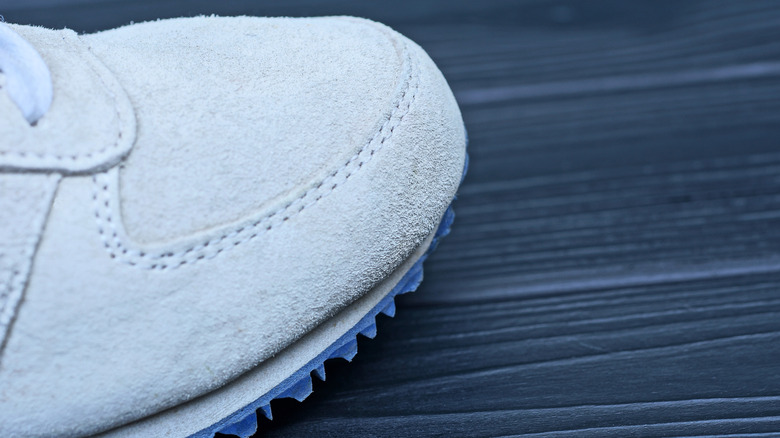Close up of white suede sneakers