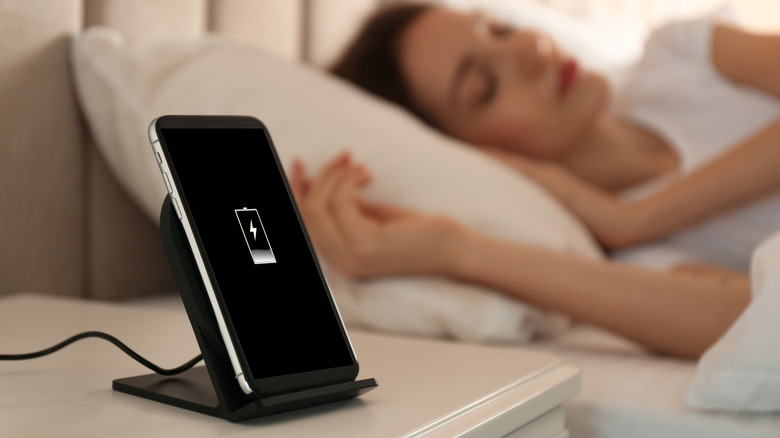 woman sleeping while phone charges