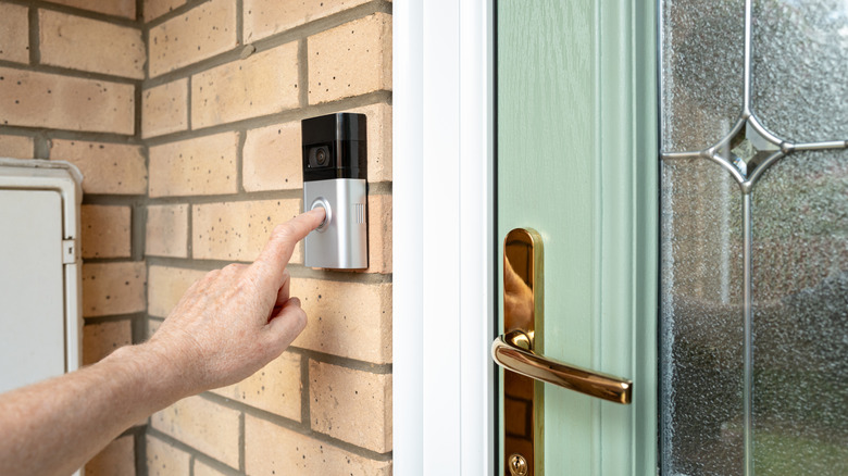 A person ringing a video doorbell camera